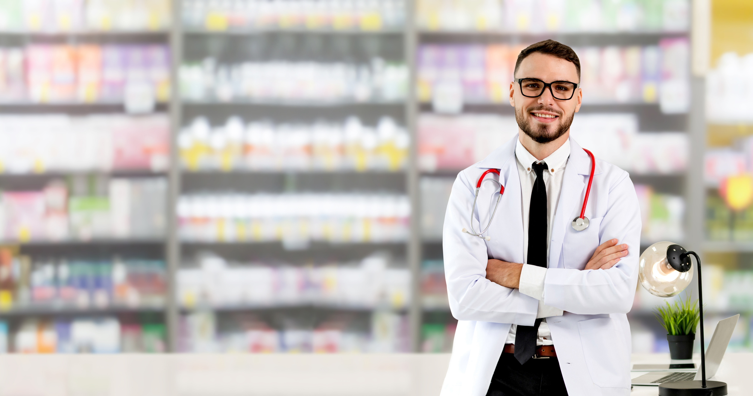 Pharmacist standing in pharmacy room.